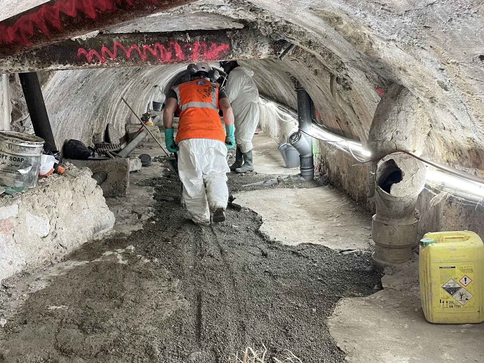 Work crew in a vaulted sewer gallery under rehabilitation, Barmassa valley